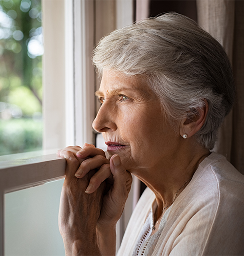 Elder person looking through the window